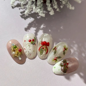 Handmade 3D Christmas press-on nails with festive silver glitter and bow accents