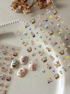 Detailed close-up of embossed rabbit nail art stickers with pastoral flower basket designs