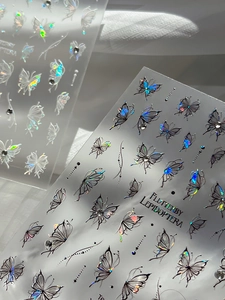 Macro shot of 3D aurora butterfly nail stickers with delicate rhinestones and shimmer