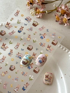 Macro shot showing 3D embossed cute rabbit nail stickers with floral patterns on PET film