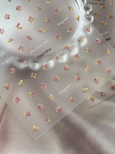 Detail of pink and purple floral nail stickers with gold accents on model YT6815Pro