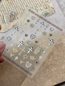 Baroque nail stickers featuring gold and silver crosses and hearts on vintage paper