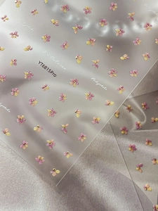Macro shot of YT6815Pro pink and yellow gradient 3D flower nail art stickers with beads