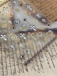 Macro detail of YT083 Baroque nail stickers with gold and silver gothic cross designs