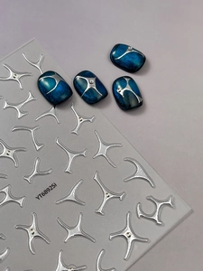 Macro shot of silver 3D metal star nail stickers and blue cat-eye nails YT6892Si