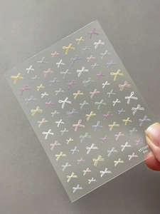 Macro detail of YT7169 nail stickers featuring macaron bow patterns on translucent film