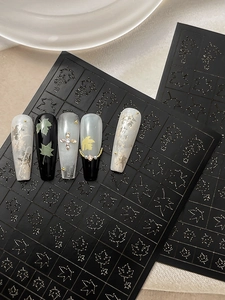 Detailed view of hollow maple leaf nail stickers with chic black matte finish and autumn style