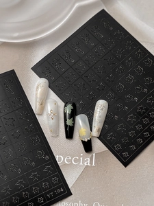 Macro shot of maple leaf nail stickers with detailed patterns on diverse manicure tips
