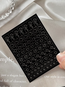 Detailed view of hollow maple leaf nail art stickers with delicate white outlines