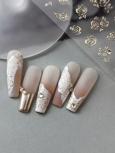 Detail of 5D embossed gold rose nail stickers with 3D flower texture and rhinestones