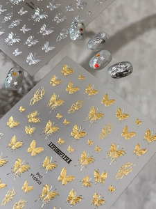 Detailed macro view of 3D gold and silver butterfly nail art stickers YT6993 and YT6994