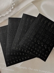 Detailed view of black laser silver maple leaf nail stickers with intricate hollow patterns