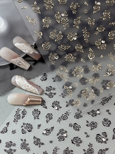Detail of vintage rose nail stickers with gold relief and black outlines on tips