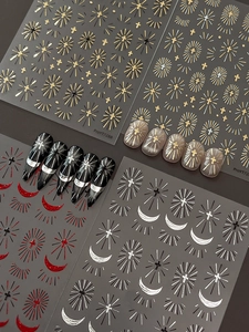 Detail of silver and gold holy cross nail stickers with moon patterns and glitter