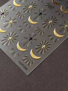 Detail of silver cross and golden crescent moon embossed nail art stickers on black background