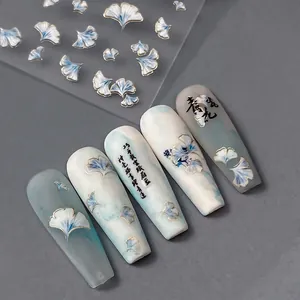 Gingko leaf press-on nails with blue-white gradient and gold foil ginkgo nail stickers