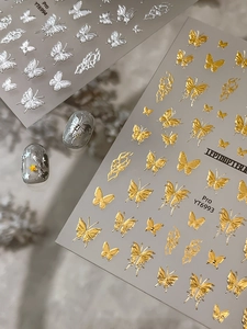 Detailed 3D embossed butterfly nail stickers in metallic gold and silver finishes