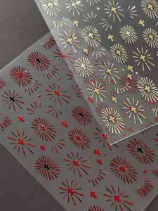 Detail of silver cross and starburst nail art stickers with glitter finish