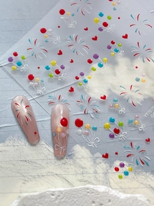Detail of cute colorful balloon and fireworks nail art stickers on nude pink nails