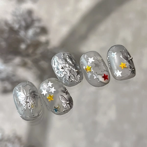 Handmade Y2K nails with 3D silver butterflies and colorful star sequins on grey base