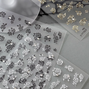 Sparkling gold embossed rose nail stickers with 3D diamond accents and floral designs