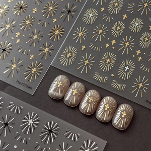 Silver and gold cross nail stickers on grey background showing elegant application effect