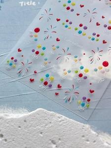 Macro detail of 3D embossed jelly nail art stickers with balloon and fireworks patterns
