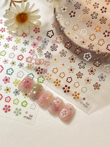 Detail of floral nail art stickers showing pastel colors and embossed 3D flower textures