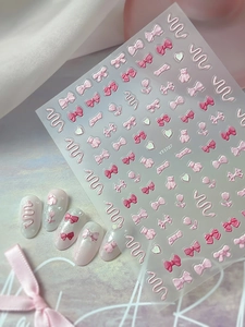 Detail of 3D embossed nail stickers featuring pink bows, hearts and cute bear patterns