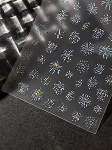 Macro shot of 3D holographic firework nail stickers with rainbow light reflection