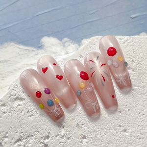 Jelly balloon fireworks press-on nails with long coffin shape on textured stone block