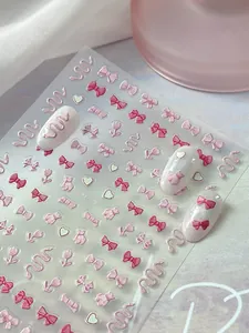 Detail view of 3D embossed nail stickers featuring pink bows, bears, and tulips