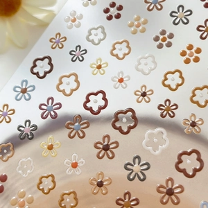 Floral nail art stickers with gold foil daisies in earth tones and 3D embossed texture