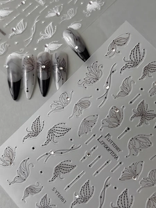 Detail of 3D embossed butterfly nail stickers with rhinestones and elegant ink style
