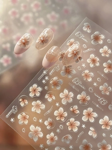 Macro shot of 3D embossed jelly floral nail stickers with pink gradient and pearl details