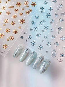 Detail of YT6956 snowflake nail art stickers with metallic gold and blue winter patterns