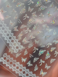 Detail of 3D embossed nail art stickers with aurora laser butterfly and lace patterns