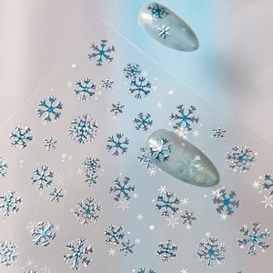Winter snowflake nail art stickers with blue metallic holographic luster for holiday manicure
