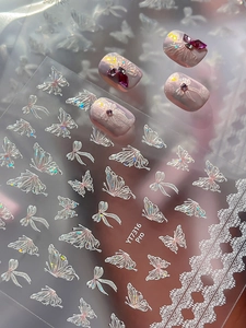 Close-up of iridescent butterfly nail stickers with holographic laser shell finish