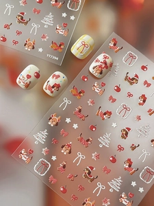 Detailed view of 3D embossed Christmas nail art stickers with cute dog and tree patterns