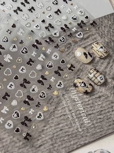 Detail of 3D embossed bow and heart nail art stickers with gold foil accents YT7166