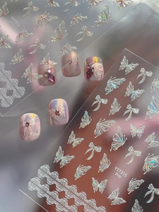 Macro detail of 3D iridescent butterfly and lace nail stickers with embossed texture