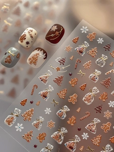 Detailed 5D embossed Christmas nail stickers with gingerbread man and snowflake patterns