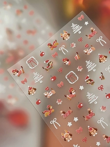 Macro detail of 3D embossed Christmas nail stickers featuring cute puppies and trees