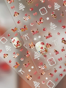 Macro detail of 3D embossed Christmas dog nail art stickers with festive tree patterns