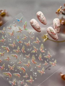 Detail of 3D laser butterfly nail art stickers with iridescent heart motifs on pink tips