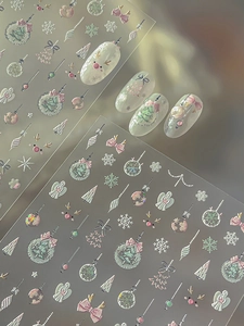 Close-up of 5D embossed Christmas nail stickers featuring snowflakes and pink bows