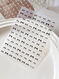 Détail des stickers nail art nœuds en relief 3D YT7158 en noir et argent sur céramique