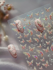 Macro detail of 3D butterfly nail art stickers with iridescent relief and laser finish