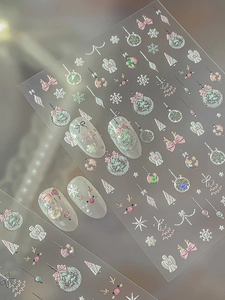 5D embossed Christmas nail stickers featuring pink bows and snowflakes on clear nails